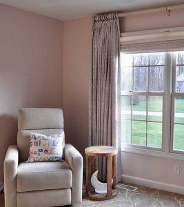 baby nursery with room darkening shades and drapery