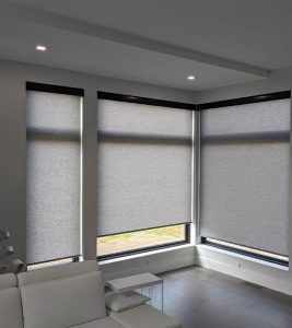 gray roller shades in white living room