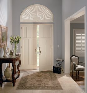 Interior shutters on arched window and front door