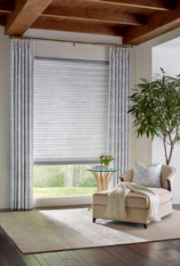 layered drapery window covering with blue pattern in living room