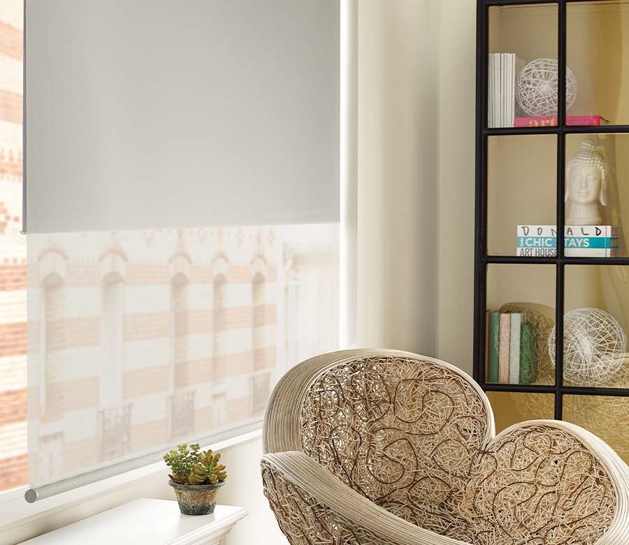 dual window shade with gray liner and opaque fabric next to funky woven chair