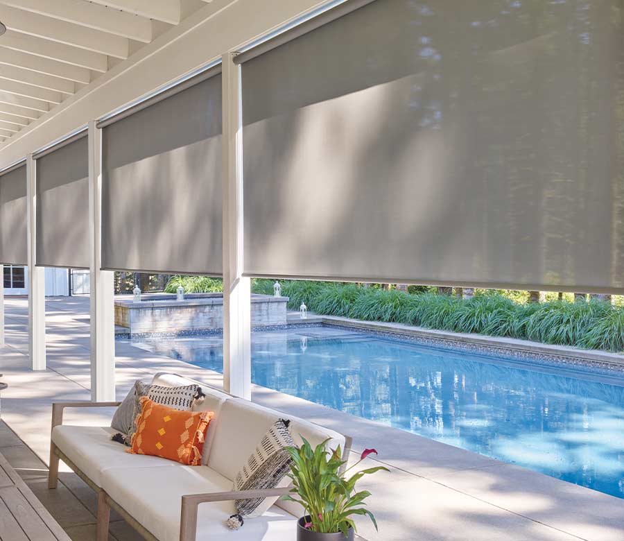 poolside sunroom with roller shades in Lakewood OH home, shades partway down in energy efficient fabrics