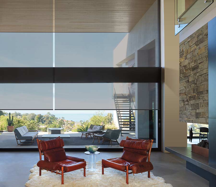 opaque roller shades on large window facing outdoor patio space with chairs in Cleveland OH home