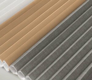 detail of different fabrics for a double cell shade in tan, gray, and white