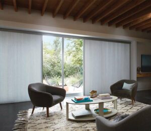 large glass sliding patio door leading to backyard seating area covered by vertical cellular shades in Chagrin Falls