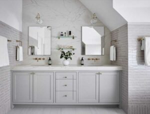 marble accent wall in primary bathroom with roof slope