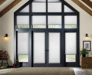 Applause® Honeycomb Shades covering a peaked black trim set of windows