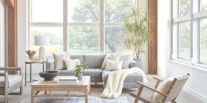 cozy natural textured living room with floor to ceiling windows without treatments