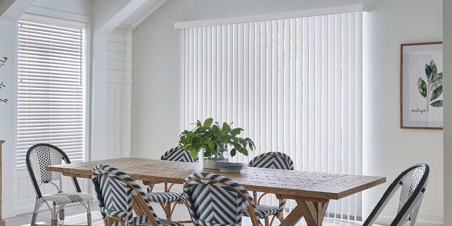 dining room with white vertical blinds