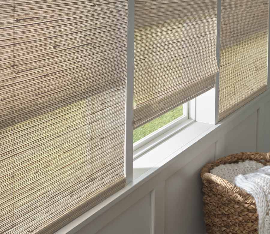 Living room with textured brown woven wood shades