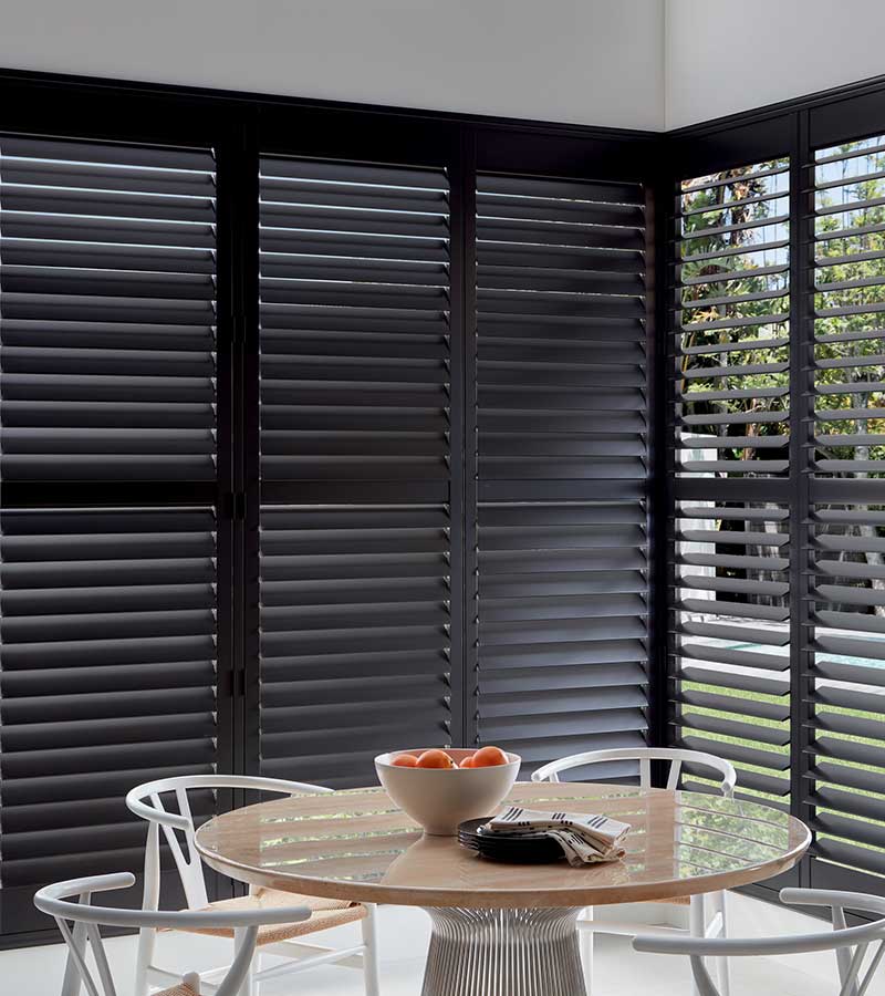 dining room with black wood shutters