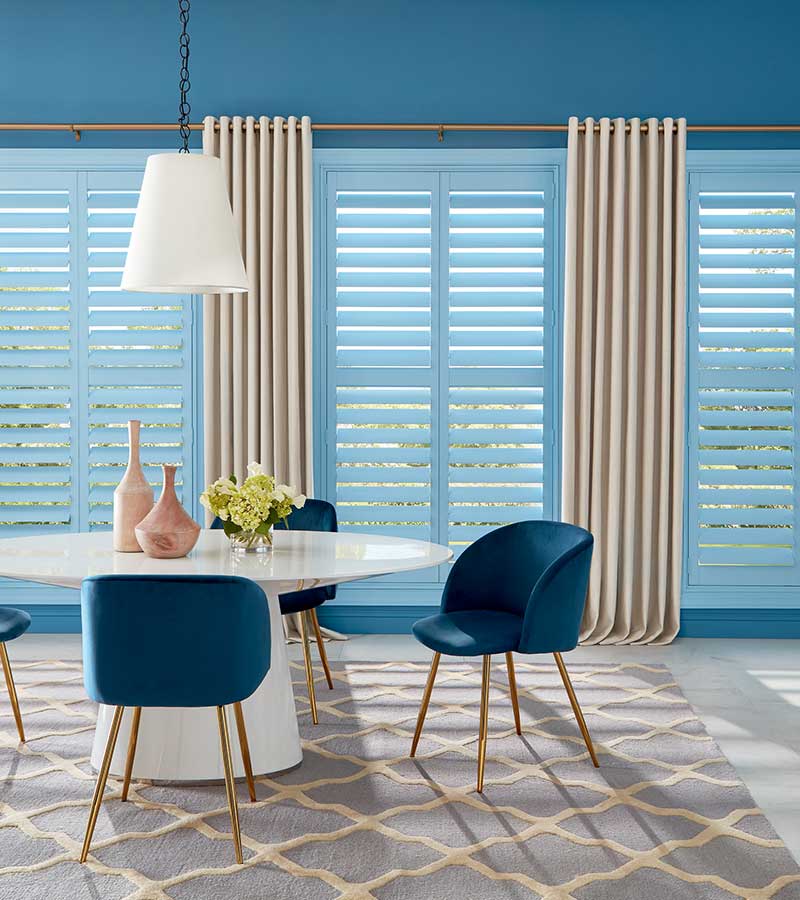 dining room with blue shutters