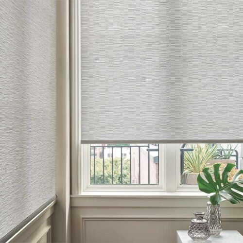 designer-roller-shades-corner-window-hunter-douglas-timan-and-co gray designer roller shades on corner window