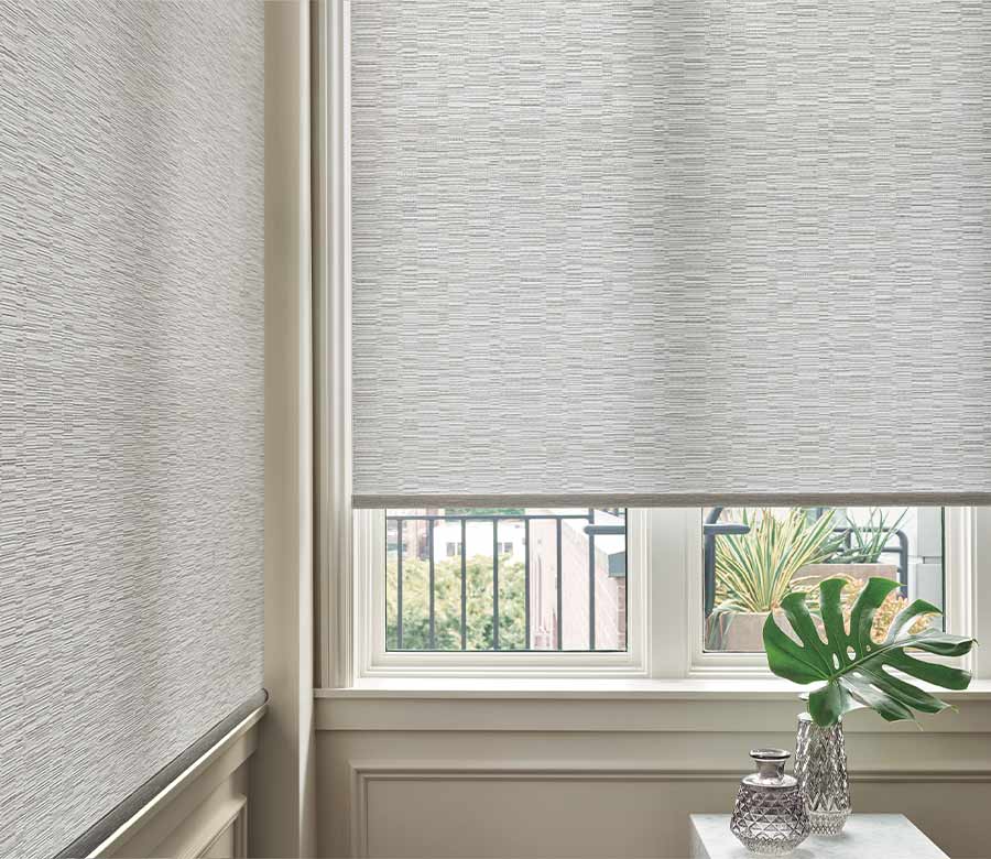 gray designer roller shades on corner window