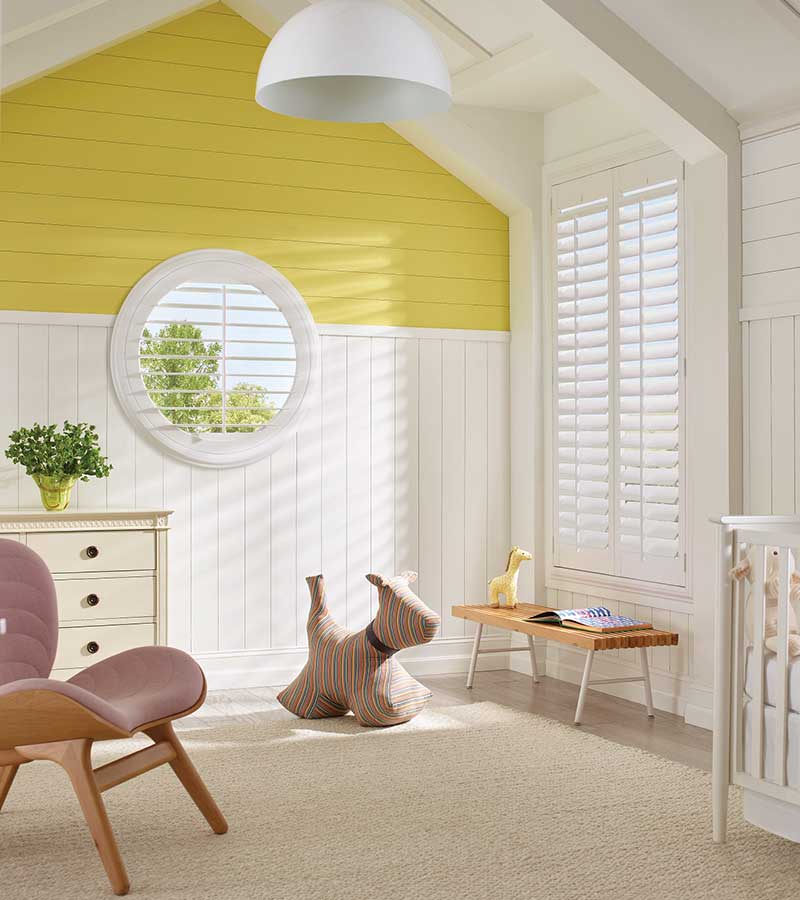 specialty shape white shutters in childs room