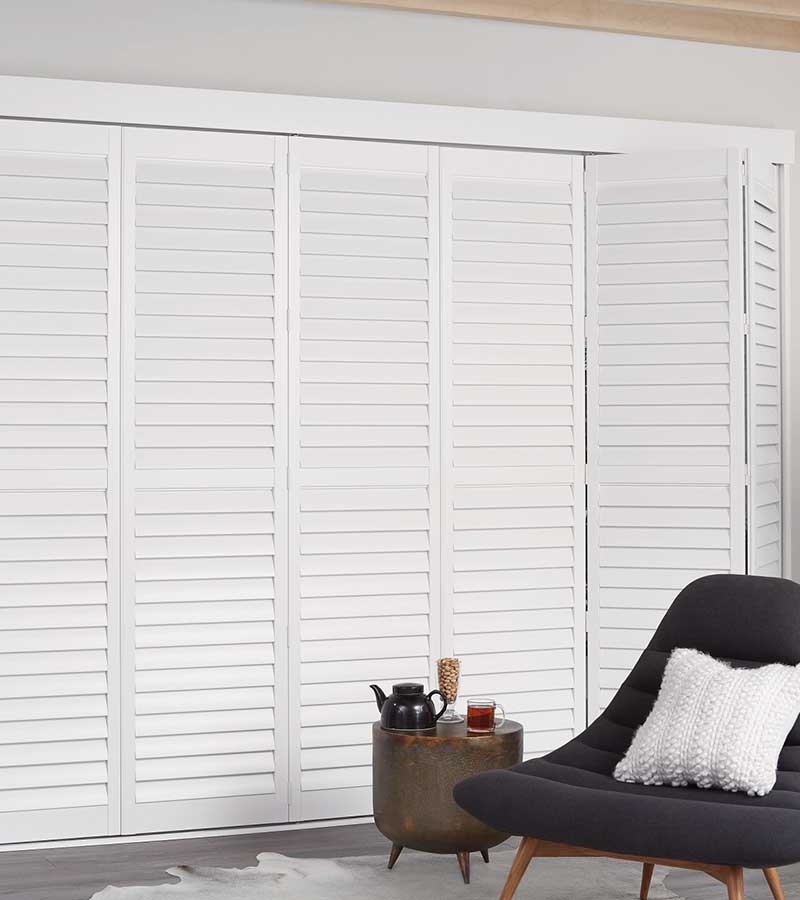 white bigfold newstyle shutters in den