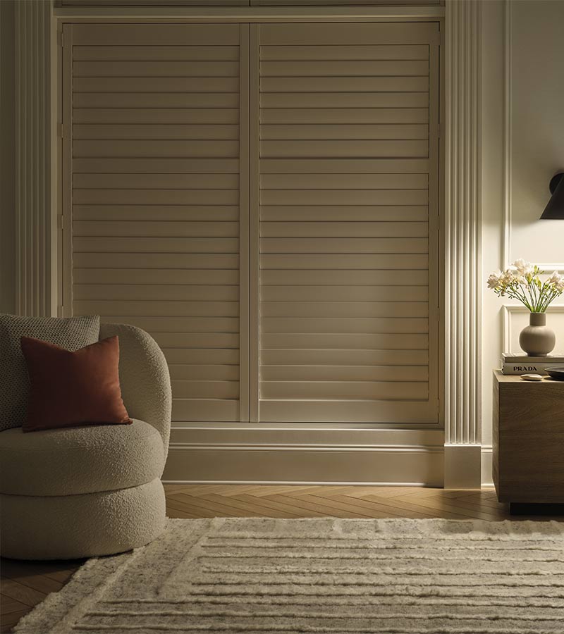 energy-efficient-palm-beach-window-treatments-timan-and-co closed shutters for energy savings and light control on large bedroom windows
