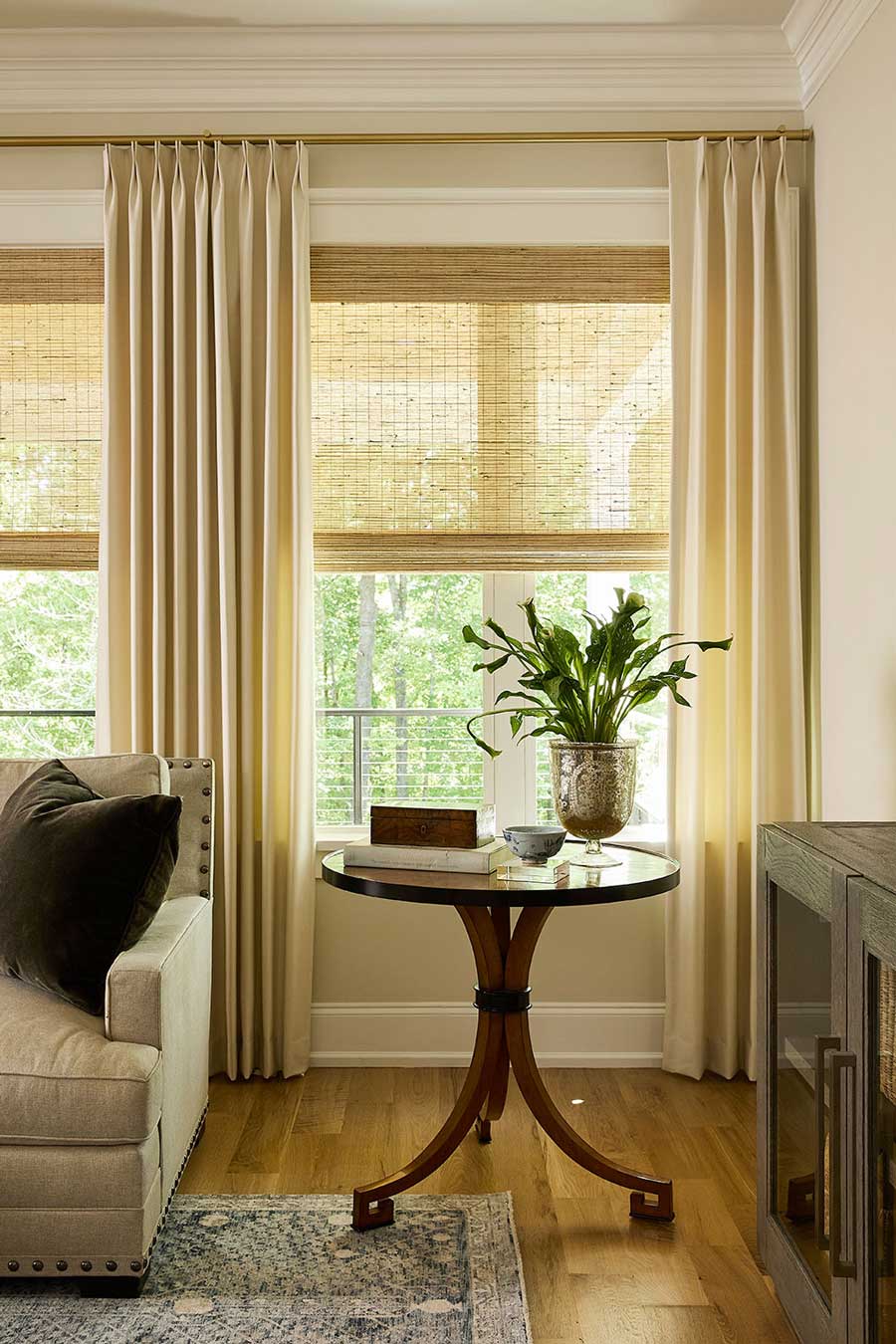 double pinch pleat draperies in living room with bamboo shades on windows of Rocky River OH home