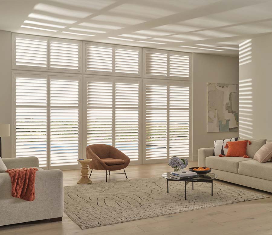 White PolySatin™ interior shutters controlling light in a Cleveland living room