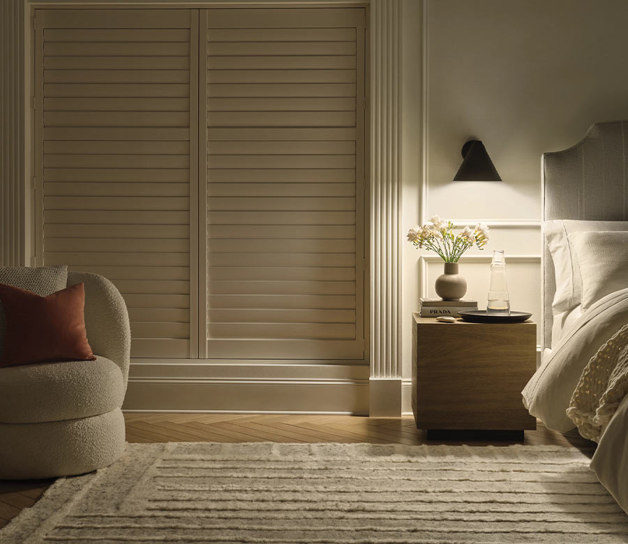 Custom PolySatin™ shutters by Hunter Douglas installed in a bedroom