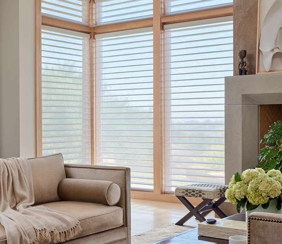 Custom Hunter Douglas Silhouette shades, enhancing corner windows with soft light control in a living room