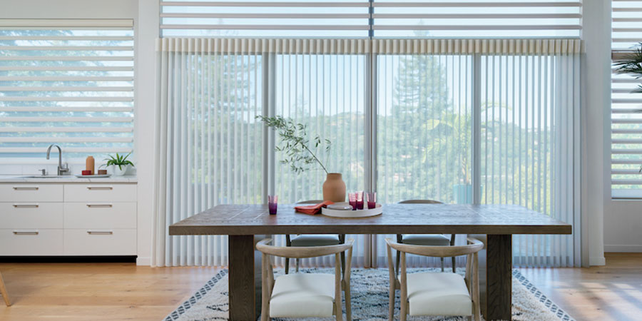 Pirouette® Shades and Luminette® Privacy Sheers on large living room windows for soft natural light and reduced glare