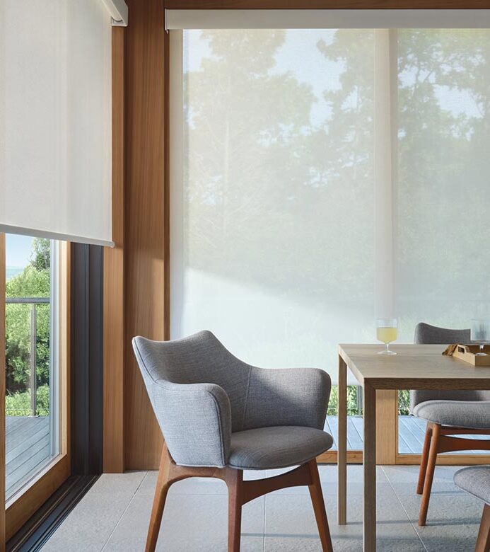 designer-screen-shades-for-floor-to-ceiling-windows-in-mid-century-modern-dining-room-timan-and-co white floor to ceiling window covering screens in dining room